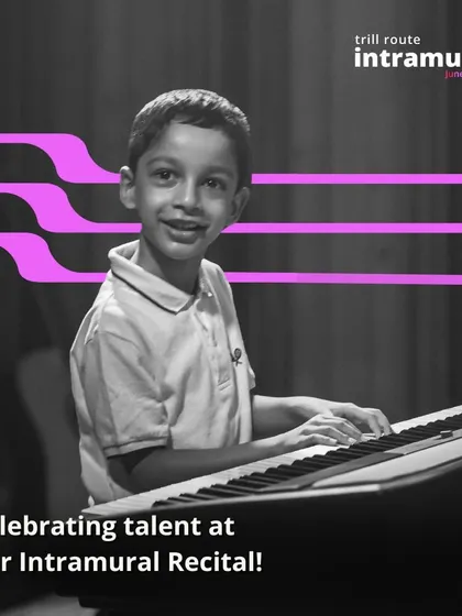 Look at that smile. A young student beams with pride at the keyboard during our Intramural Recital. We focus on creating a positive environment where every student can feel celebrated.
