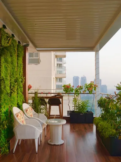 From this angle, you can see how the different elements of the terrace work together. The rich wooden flooring leads the eye from the cozy seating nook past the bar area towards the open view, creating a seamless flow.