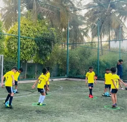 A coach and players during a footwork drill, combining skill development with fun.