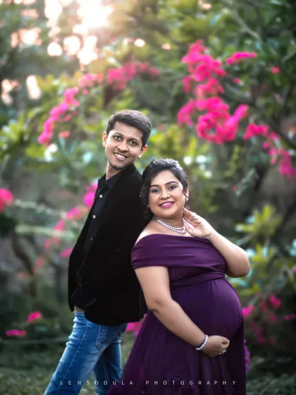 A playful and sweet back-to-back pose in a lush garden. This highlights their individual personalities while still showing their connection as a couple.