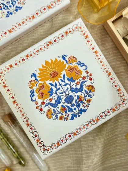 A duplicate image of the beautifully designed wedding invitation box lid, highlighting the intricate floral artwork.