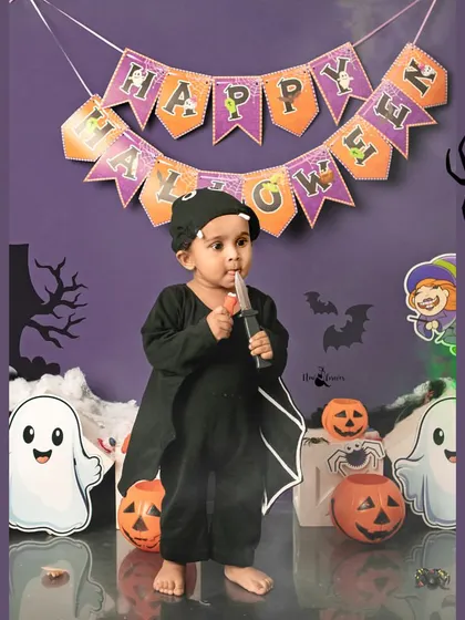 A spooky-cute bat ready for Halloween. This toddler is enjoying the props in our fun and festive Halloween mini-session.