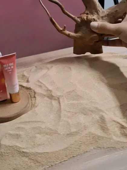 Placing the driftwood prop in the sand for the Mars "Dusk" blush shot.