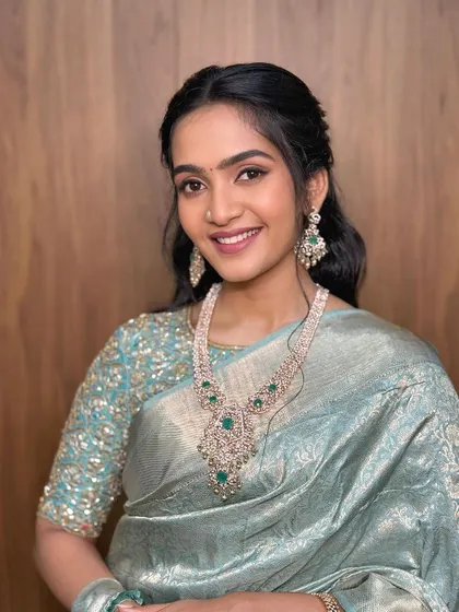 A timeless and simple look featuring a soft, winged liner and a unique saree drape.