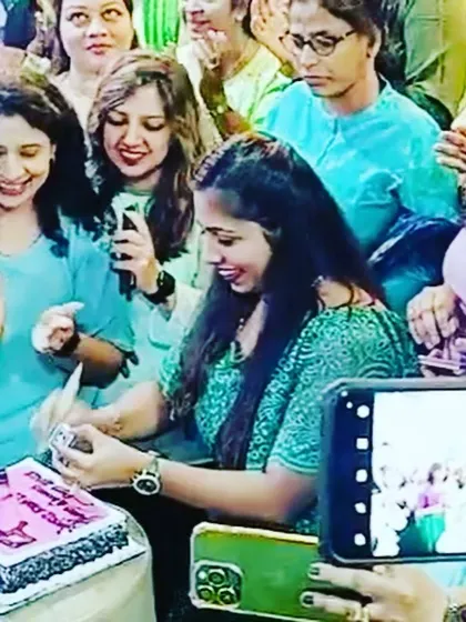 A similar shot of the Women's Day cake cutting, capturing the happy faces in the crowd.