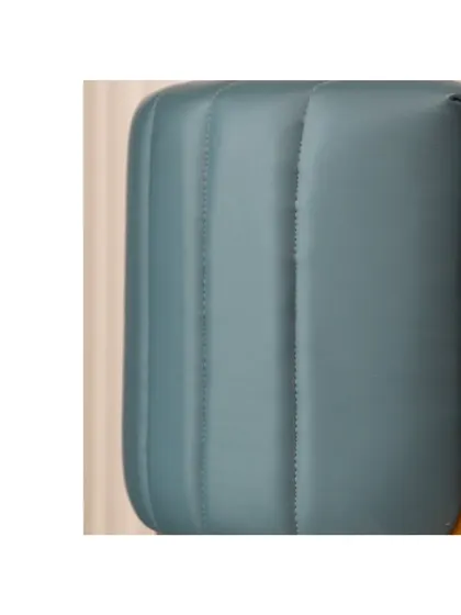 A detail of the channel-stitched upholstery on the arm of the accent chair. This technique adds texture and a sense of luxury to the piece, making it a true statement chair.