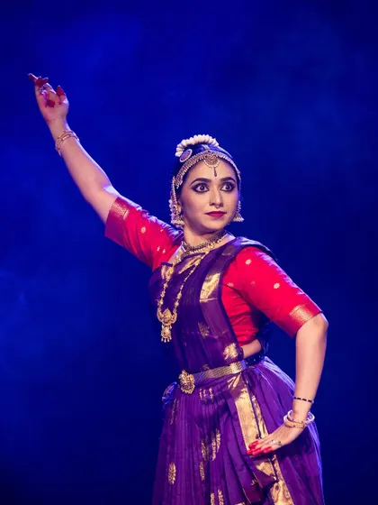 Meera Krishna in a moment of powerful expression, her posture commanding the stage.