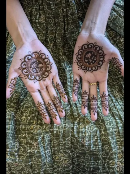 A closer look at the matching mandala designs for the bride's sister. The central lotus is surrounded by a simple, clean border.