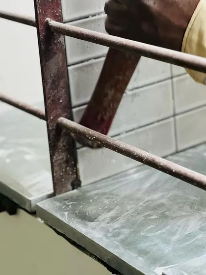 A collection of images and videos documenting various stages of construction, from site visits and foundation work to the detailed installation of architectural fittings and finishes.