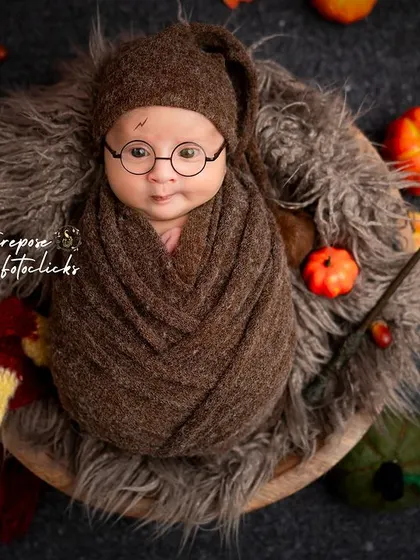 Another angle of our detailed Harry Potter setup, showing the newborn nestled amongst books of spells and other magical artifacts.