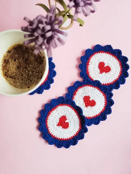 Our heart-themed coasters are perfect for sharing a cup of coffee with a loved one. The design features a red heart at the center with a blue scalloped edge, adding a sweet touch to your decor.