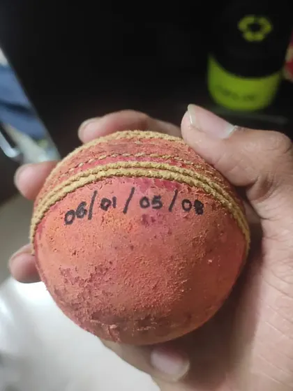 The match ball from Tanmay Jagtap's 5-wicket haul, with his figures written on it. A prized possession for any bowler.