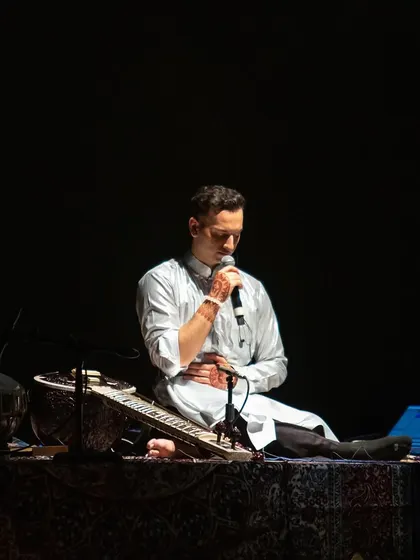 Leading the audience in a guided meditation during a tour stop. This is a key part of how I integrate wellness into my live shows.