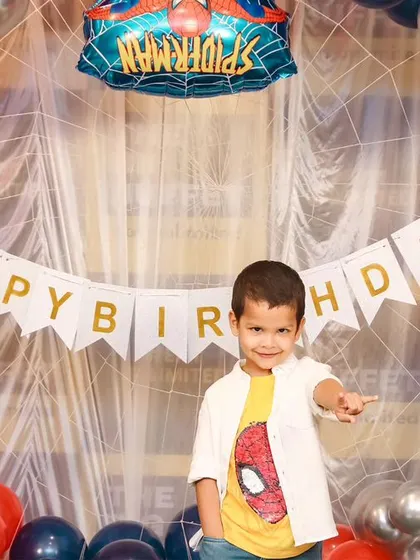 A charming 'Baby Shark' themed birthday party, featuring a vibrant underwater backdrop, character cutouts of the shark family, and blue and yellow balloons, perfect for a fun-filled celebration.