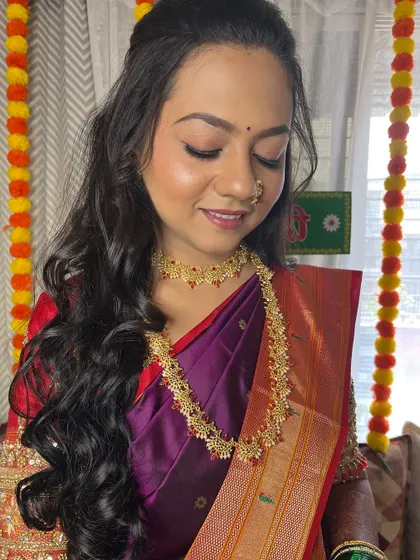 A close-up of the soft, glowing makeup and loose curls.