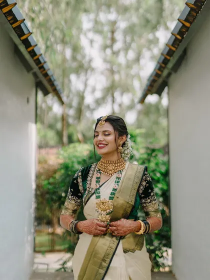 A beautiful bride in a classic Sabyasachi saree, captured in a candid moment of happiness.