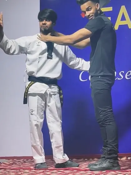 The final position of the choke defense demonstration. It shows how to create space and control the attacker's posture.