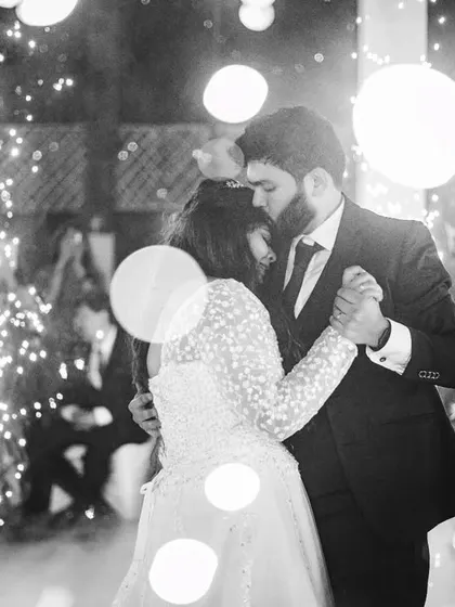 A romantic first dance moment, captured in black and white with beautiful bokeh and sparklers. The image is full of magic and emotion.