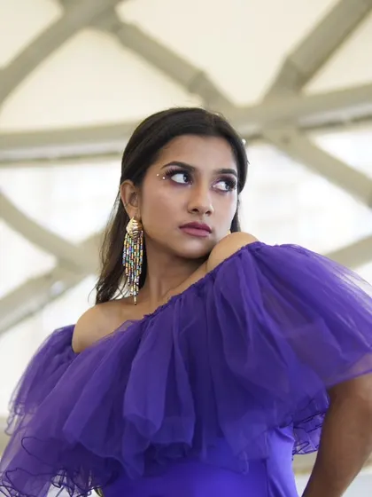 A close-up portrait focusing on the unique eye makeup and the model's expression. This is a great example of creative photoshoot makeup.