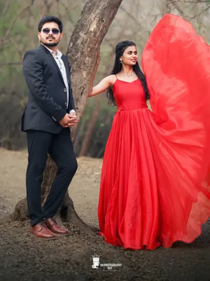 A fun and candid moment between the couple. The bride's simple red ball gown allows her joyful expression to be the main focus of this lovely pre-wedding photo.