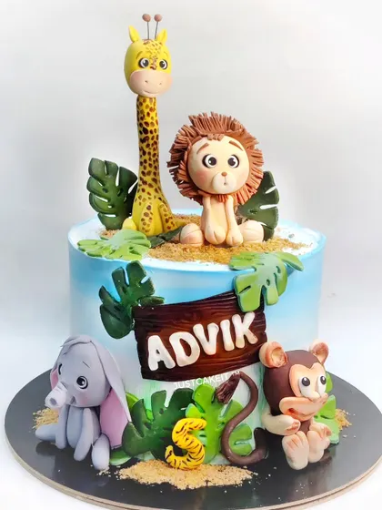 This jungle animal cake is overloaded with cuteness, featuring a hand-molded lion, giraffe, elephant, and monkey. All the figures on this chocolate truffle cake are edible and safe for kids.