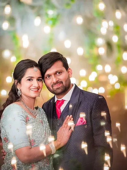 A sweet moment between the couple at their reception, surrounded by the warm glow of decorative lights.