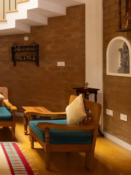 A detailed shot of the living space, showing a niche carved into the earth block wall for a sculpture, blending art and architecture.