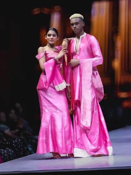 This is another angle of the stunning pink collection, showing the full length of the garments. Capturing models together on the runway helps tell a broader story about the designer's collection.