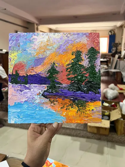 A student's colorful landscape painting, created using palette knives. Notice how the reflections in the water are captured with bold strokes and thick paint.