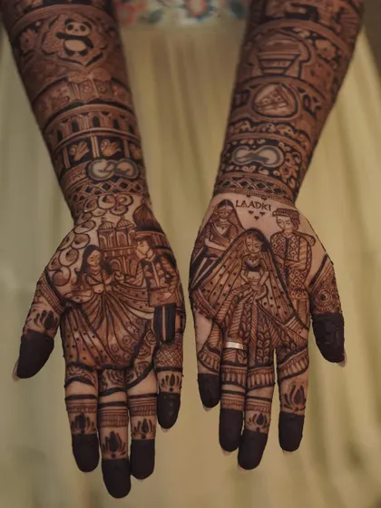 For my bride Krupa, we included portraits of her and her family, her beloved panda, and special dates. Every element in this bridal mehendi holds a special meaning for her.