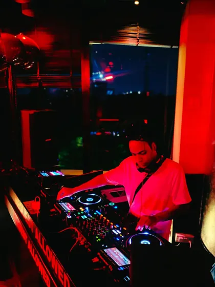 Another angle from a red-lit club night, showing my full setup in action. I'm experienced in working with different club lighting and sound systems.
