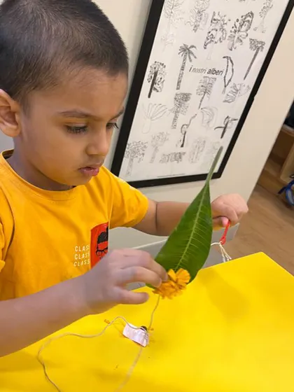 Stringing flowers onto a leaf is a delicate task that requires immense concentration and fine motor precision. This activity enhances hand-eye coordination and introduces early patterning skills in a beautiful, natural way.