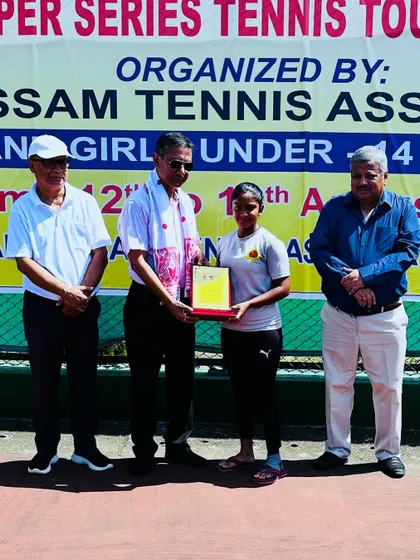 Eshita receiving her Singles Finalist plaque at the U-16 SS in Guwahati from tournament officials.