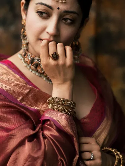A detail shot focusing on the hands, jewelry, and the thoughtful expression. These small moments add depth to a portrait series.