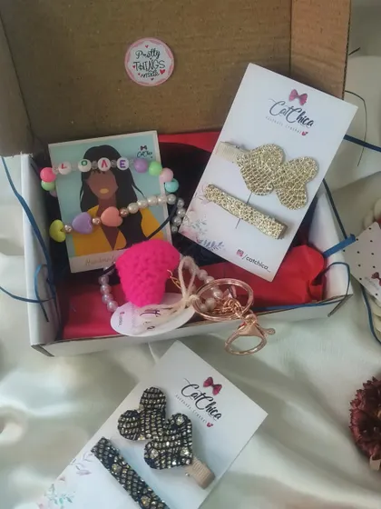 Our "Love Hamper" is the perfect gift for your loved one, containing a mix of bracelets, a keychain, and hair clips in a pretty gift box.