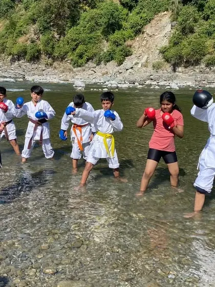 Teaching a kids' karate class right in the middle of a river. Training in water adds a new level of resistance and challenge, helping them build strength and balance in a fun way.