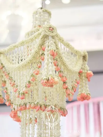 An enchanting chandelier made entirely of fragrant jasmine (mogra) and delicate pink lotuses. This was a stunning centerpiece for a traditional half-saree function, filling the air with a beautiful scent.