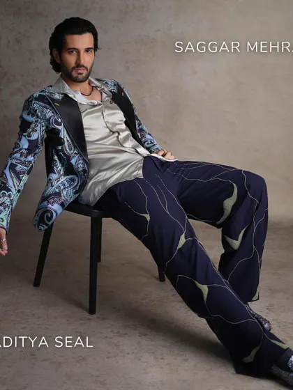 This full-length shot from the FHM India cover shoot shows how the entire ensemble comes together. The relaxed posture and confident styling reflect a modern approach to men's formalwear.