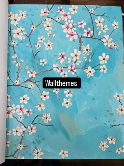 A sample of a cherry blossom wallpaper with a vibrant turquoise background from a design catalog.