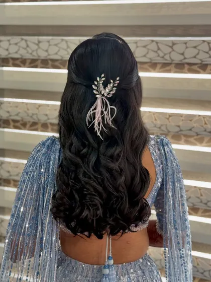Another angle of this stylish half-updo, showing how the accessory catches the light and complements the sparkling outfit.