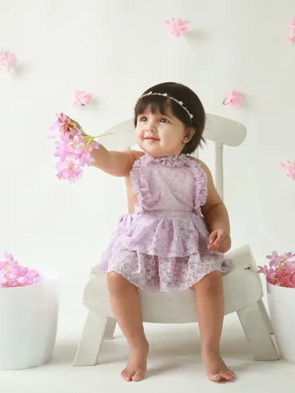 A sweet and simple floral theme. This little girl in a lavender dress, surrounded by pink blossoms, looks like she's in her own secret garden.