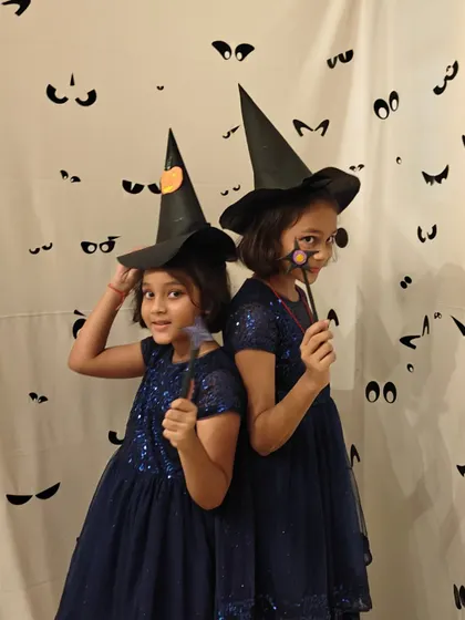 Double the trouble, double the fun. These two friends are perfectly coordinated in their witch costumes for our spooky and fun Halloween party at the club.