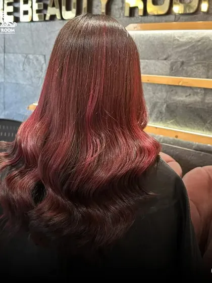 The back view of our red balayage, showing the seamless transition of color.