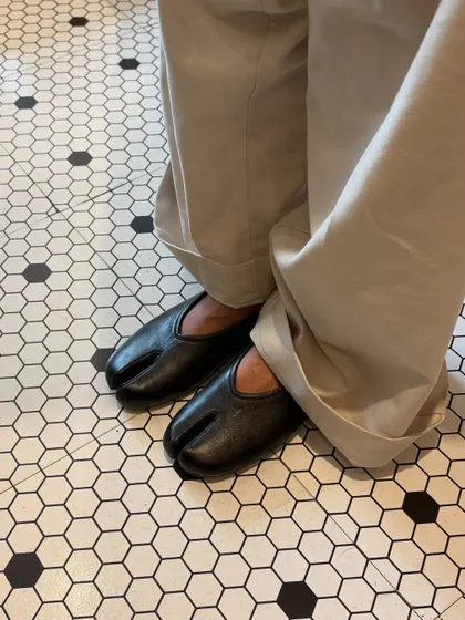 The DUPE Tabi flat in classic black leather, finding its place in a world of pattern and line. I designed this split-toe silhouette for those who appreciate a different perspective, blending traditional Japanese form with modern, everyday comfort.