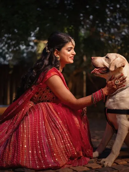 A heartwarming moment between the bride and her best friend. Including pets in wedding photos adds a layer of personal story and pure, unconditional love.