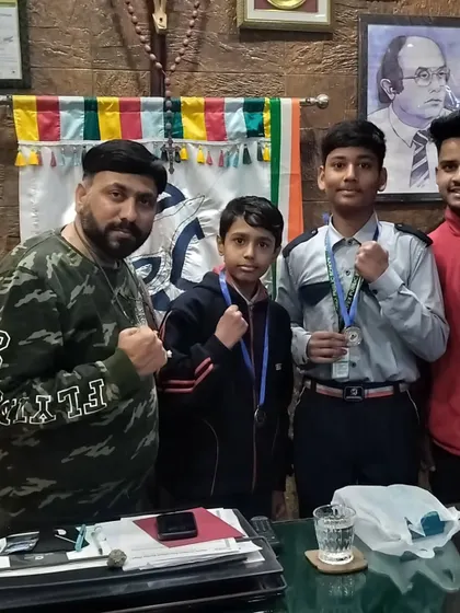 Our champions with the school principal. We believe in celebrating every achievement, big or small, to motivate our young boxers.