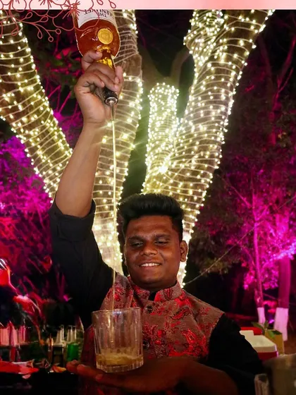 A high-pour of a classic whiskey drink, demonstrating the flair and confidence of our experienced bartending team.