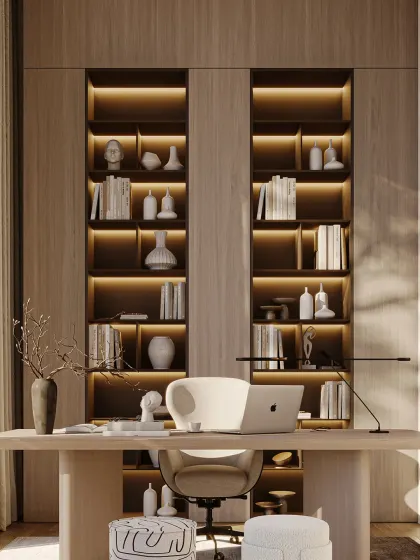 More than a workspace, this home office is a haven of creativity and focus. The warm wood tones, curated shelving with integrated lighting, and minimalist desk are composed to encourage clarity and calm.