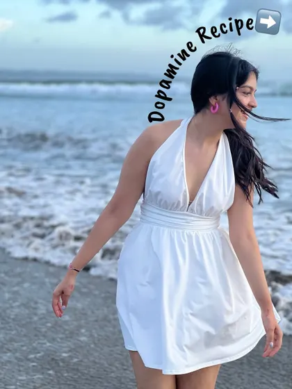 A happy moment on the beach. This white halter dress is a perfect, breezy option for a beach vacation.