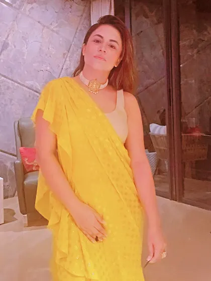 Another angle of the yellow saree look, demonstrating how the ruffled drape adds a modern, playful texture to the traditional garment.